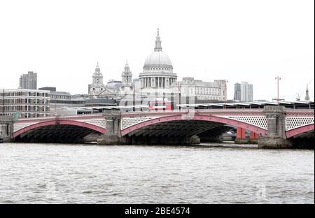 Ikonischer roter British Bus auf der Blackfriars Bridge mit St Paul`s Cathedral und London Skyline im Hintergrund, Großbritannien Stockfoto